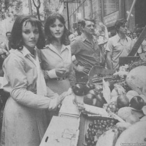 SUPERMAN II- Margot Kidder as Lois Lane and Stunt Performer Ellen Bry at the Daily News building as the Daily Planet location filming the Lois falls into a fruit cart sequence. July 11, 1977. New York. U.S. Director- Richard Donner