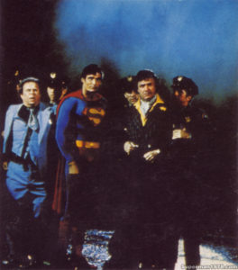 SUPERMAN THE MOVIE- Ned Beatty as Otis, Christopher Reeve as Superman, Gene Hackman as Lex Luthor. October 1977. Pinewood Studios backlot