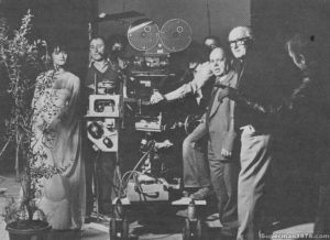 SUPERMAN THE MOVIE- Margot Kidder as Lois Lane, unknown, Cameraman Peter MacDonald (behind camera lens), Flying Systems & Process Projectionist Wally Veevers, Cinematographer Geoffrey Unsworth, unknown (with back to camera). October/November 1977. M Stage, Pinewood Studios, England.
