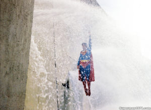 SUPERMAN THE MOVIE- Christopher Reeve as Superman on the Hoover Dam mock up. March 1978. Pinewood Studios backlot.